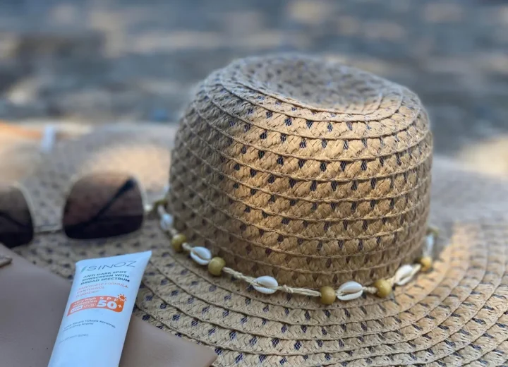 Kobieta aplikująca krem z filtrem SPF na twarz zimą na tle ośnieżonego krajobrazu